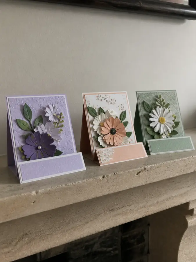 Three easel cards on a mantel